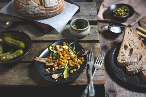 Close up of delicious antipasto meal of bread, pickles, roasted vegetables and chickpeas - Australian Stock Image
