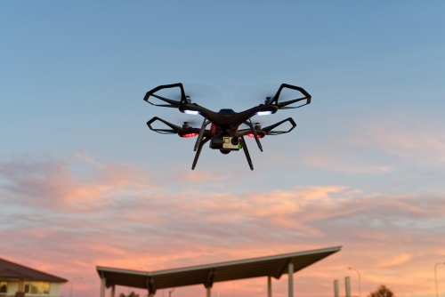 Close-up of drone, uav, rpas flying at sunset with copy space