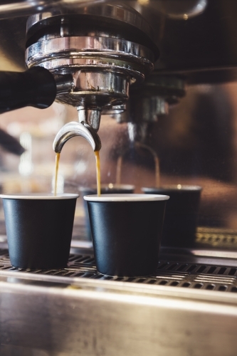 Close up of espresso machine making coffee in a cafe - Australian Stock Image
