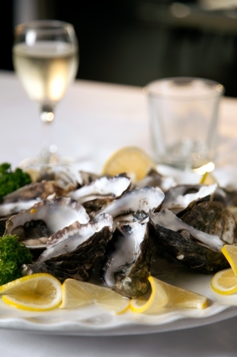 Close up of fresh oysters on a plate in a restaurant - Australian Stock Image