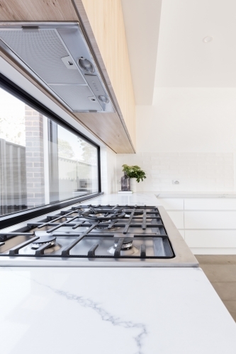 Close up of gas cooktop in a contemporary new kitchen - Australian Stock Image
