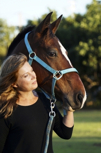 Close up of headshot of woman and horse