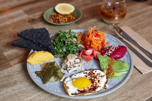 Close-up of healthy vegetarian meal on wooden table - Australian Stock Image