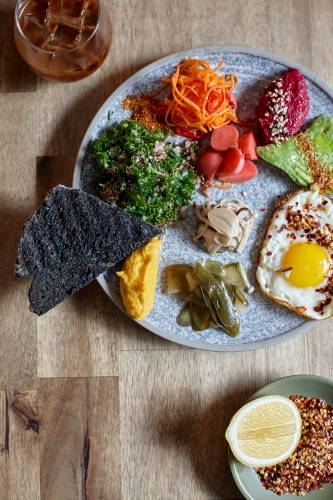 Close-up of healthy vegetarian meal on wooden table - Australian Stock Image