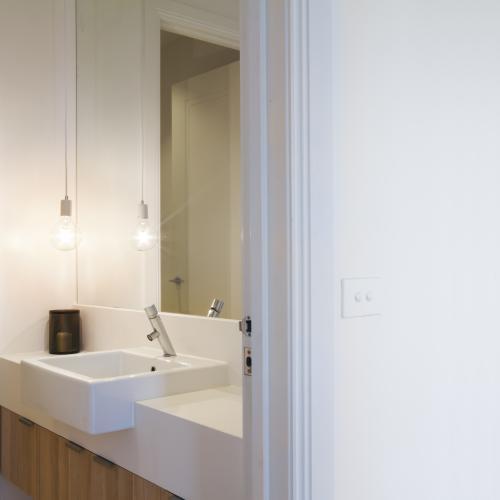 Close up of light switch on wall and pendant light in bathroom of luxury home - Australian Stock Image