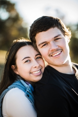 Close up of man and woman couple heads together smiling
