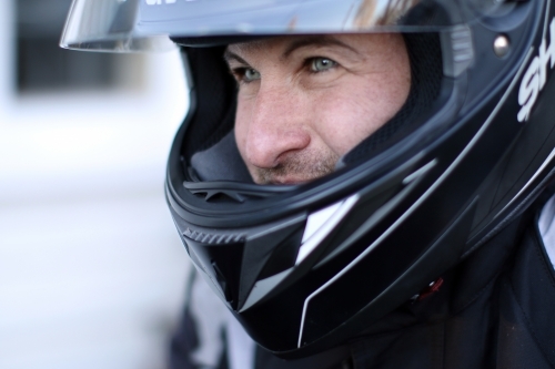 Close up of man wearing a motorbike helmet - Australian Stock Image