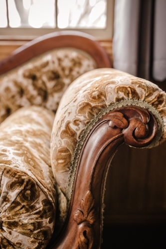 Close-up of old loveseat arm