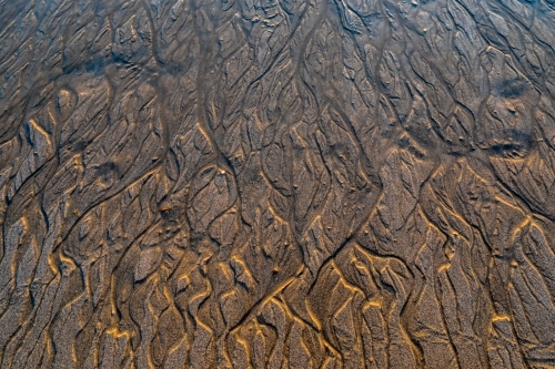Close up of pattern in sand at low tide - Australian Stock Image