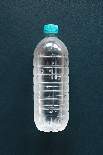 Close up of plastic water bottle on blue background
