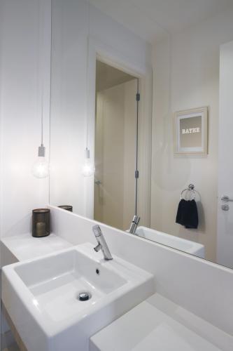 Close up of powder room basin tap and pendant lighting in modern home