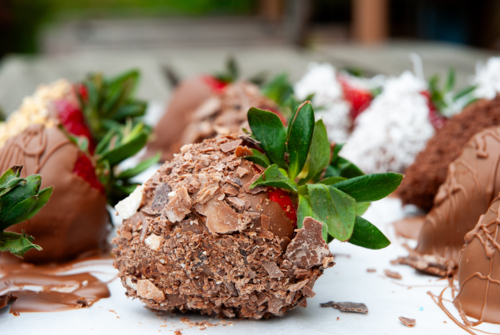 Close up of strawberries coated in chocolate on a plate - Australian Stock Image
