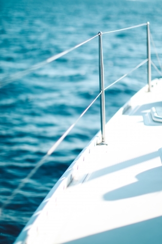 Close up of the wire railing of a boat on the ocean