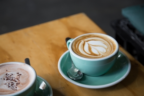 Close up of two coffee cups on a table in a cafe