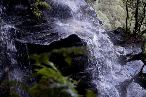 Close up of water cascading down rocks - Australian Stock Image