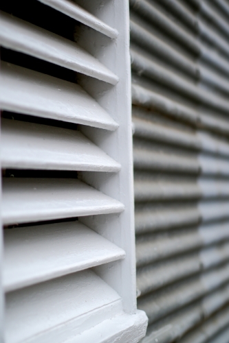 Close up of white timber louvre on corrugated iron shed - Australian Stock Image