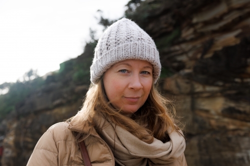 Close-up of woman with cliff face bakground - Australian Stock Image