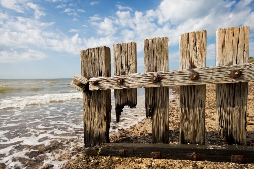close up of wooden groyne at a regional beach - Australian Stock Image
