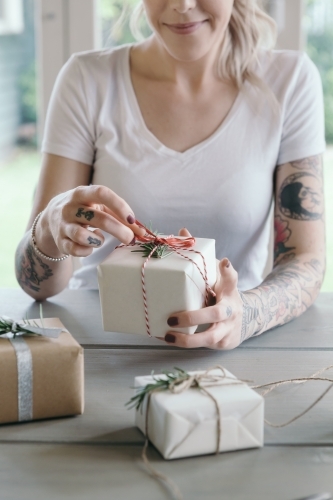 Close up of young female with gift wrapped Christmas present - Australian Stock Image
