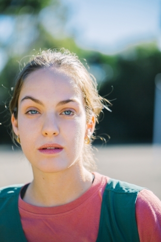 close up photo of a young woman with brushed up hair, blue eyes and fair complexion - Australian Stock Image