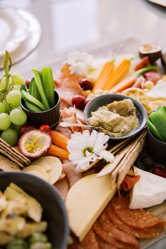 Close up photo of grapes, dragon fruit, cucumber, cheese, ham, fruits and vegetables - Australian Stock Image