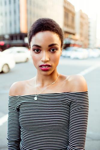 Close up portrait of a woman standing in the city on a street - Australian Stock Image