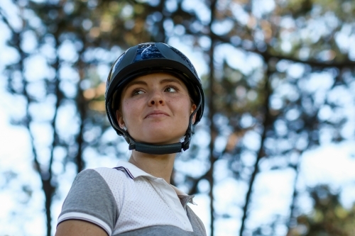 Close up portrait of young female horse rider wearing helmet - Australian Stock Image