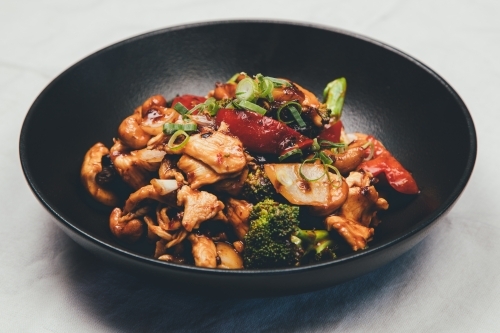 Close up shot of a bowl of stir fried meat and vegetables