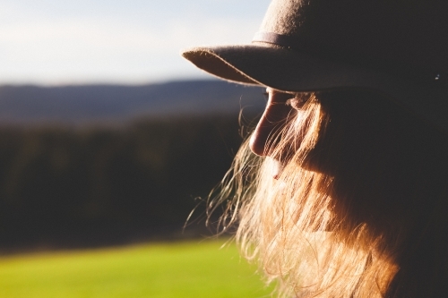 Close-up shot of a woman with countryside in the background - Australian Stock Image