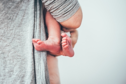 Close up shot of baby's feet and man holding the baby