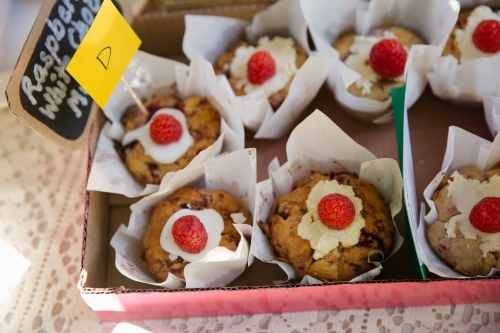 Close up shot of raspberry with chocolate muffins in a pink box - Australian Stock Image