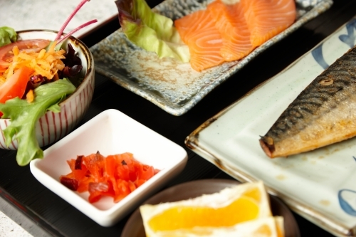 Close up shot of salmon cuts and side dishes - Australian Stock Image
