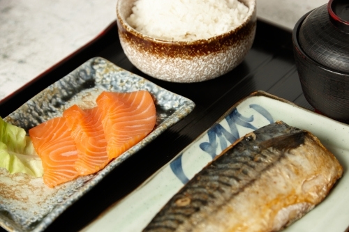 close up shot of salmon cuts, fried fish and rice - Australian Stock Image