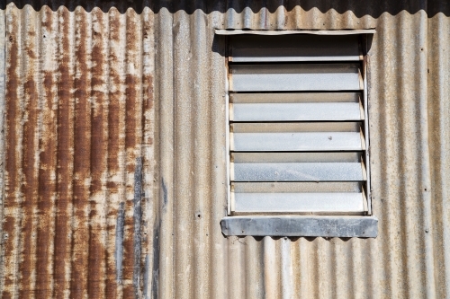 Closed window in old tin shed - Australian Stock Image