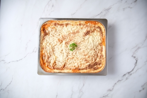 closeup of a baked dish on a marble counter - Australian Stock Image
