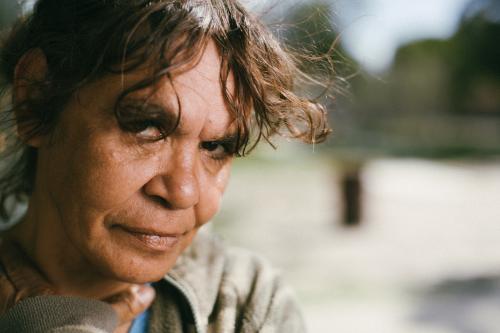 Closeup of Aboriginal Woman on a Blurred Background - Australian Stock Image