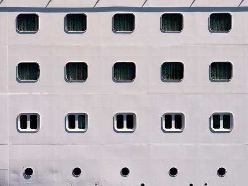 Closeup of rows of windows and portholes in a ship