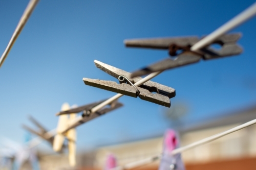 Clothesline Pegs hanging on a sunny morning - Australian Stock Image