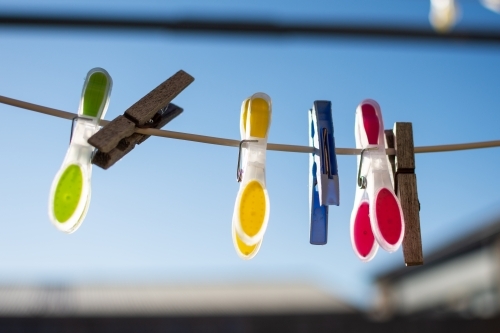 Clothesline Pegs hanging on a sunny morning - Australian Stock Image