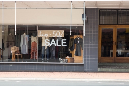 Clothing store business window with sale sign - Australian Stock Image