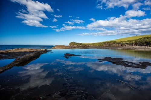 Clouds reflecting in ocean Rockpool on a sunny day