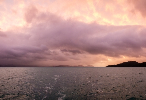 cloudy sunset over water - Australian Stock Image