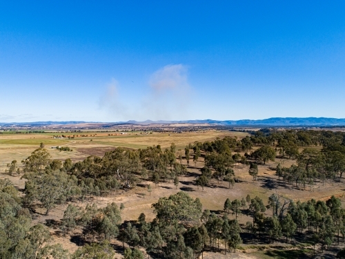 Coal dust cloud on horizon from distant mine blasting - Australian Stock Image