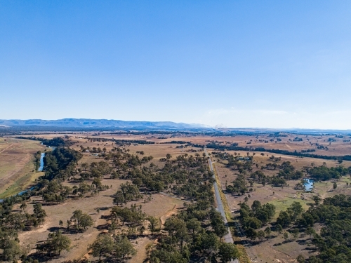 Coal dust cloud on horizon from distant mine blasting - Australian Stock Image