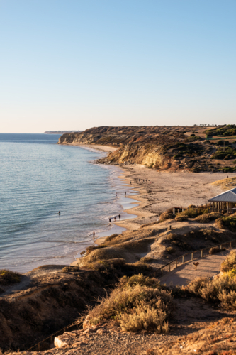 Coastal bay with people on beach, Port Willunga Beach, South Australia - Australian Stock Image