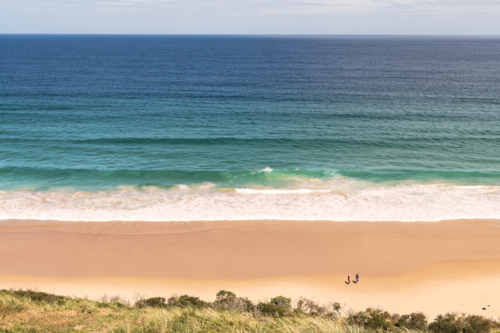 Coastal landscape shot of white sandy beach with surf - Australian Stock Image