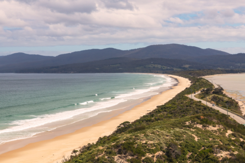 Coastal landscape shot of white sandy beach with surf - Australian Stock Image