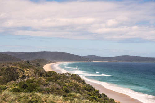 Coastal landscape shot of white sandy beach with surf - Australian Stock Image