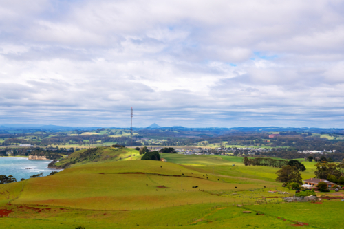 Coastal rural valley landscape with hills in the distance, Tasmania - Australian Stock Image