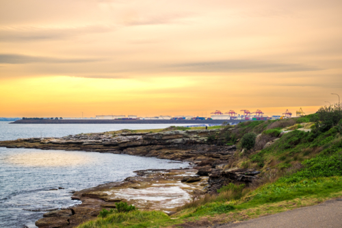 coastal sunset at La Perouse with Port Botany at the horizon - Australian Stock Image